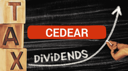 Imagen que muestra una pizarra y dados con letras que forman la palabra tax